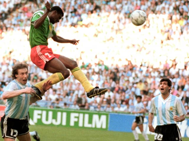 Forward Francois Omam-Biyick from Cameroon scores with a header as Argentinian defenders Nestor Lorenzo (L) and Juan Simon look on during the opening match of Italia 90  (STAFF/AFP via Getty Images)