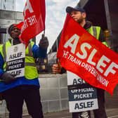 ASLEF (Associated Society of Locomotive Engineers and Firemen) members hold union flags at the picket outside Euston Station as train drivers continue their strike across the UK. (Photo by Vuk Valcic/SOPA Images/LightRocket via Getty Images)