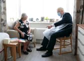 Prime Minister Boris Johnson talks to resident Kathleen during a visit to Westport Care Home in east London on September 7, 2021. - Breaking an election pledge not to raise taxes, British Prime Minister Boris Johnson today announced hefty new funding to fix a social care crisis and a pandemic surge in hospital waiting lists. (Photo by Paul EDWARDS / POOL / AFP) (Photo by PAUL EDWARDS/POOL/AFP via Getty Images)