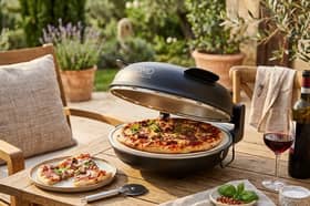 The DMD Collective electric pizza oven includes a stone baking plate and accommodates pizzas measuring up to 12 inches