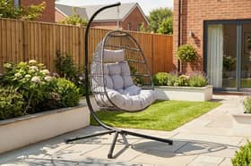 The dark grey hanging egg chair stands 202cm tall and comes with removable washable cushions