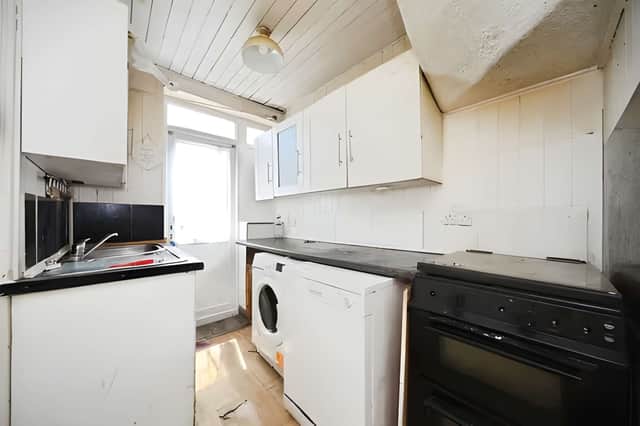 The kitchen offers new owners the freedom to redesign the home to suit modern living.