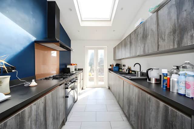 A stylish refitted kitchen with integrated appliances brings a modern touch to the property's period interior