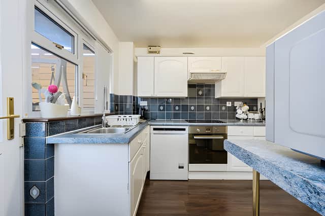 A stylish modern fitted kitchen forms part of the practical ground-floor layout, alongside a utility room and cloakroom