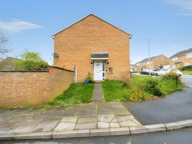 The end-of-terrace home occupies a generous corner plot, with a spacious front garden