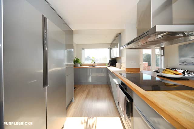 An extended kitchen and breakfast area provides space for cooking and family dining.
