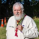 Gerald Law, Chairperson of Falkes District Scouts, poses with his award, The Silver Wolf