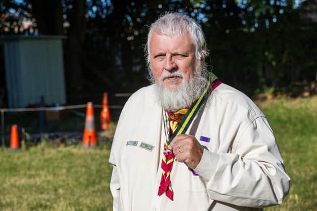 Gerald Law, Chairperson of Falkes District Scouts, poses with his award, The Silver Wolf