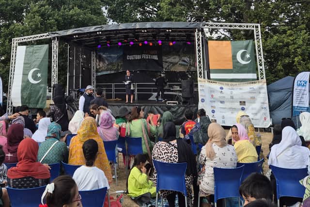 Audience gathered outdoor in front of the main stage.