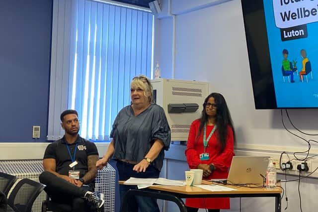 A service user delivering a powerful testimony at Total Wellbeing Luton's World Mental Health Day 2025 event.