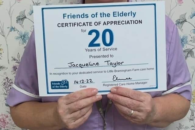 Jackie Taylor, Health Care Assistant at Little Bramingham Farm with her 20 Years Service Certificate - has now worked at the care home for 25 years.