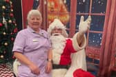 25 years caring for the residents - Jackie Taylor, Health Care Assistant at Little Bramingham Farm with Santa Claus at the care home's Community Christmas event last year.