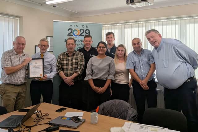Ian (far left) receives his award certificate