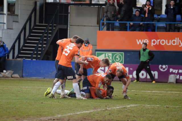 Pelly-Ruddock Mpanzu is mobbed after netting his first goal against Hereford back in February 2014