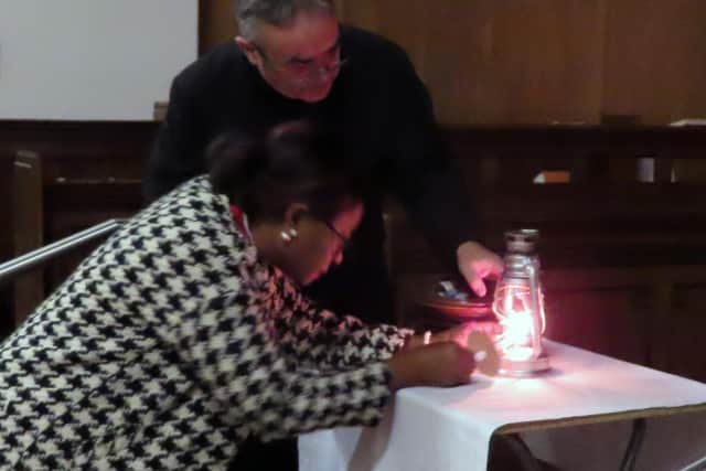 Deputy Mayor lighting the candle