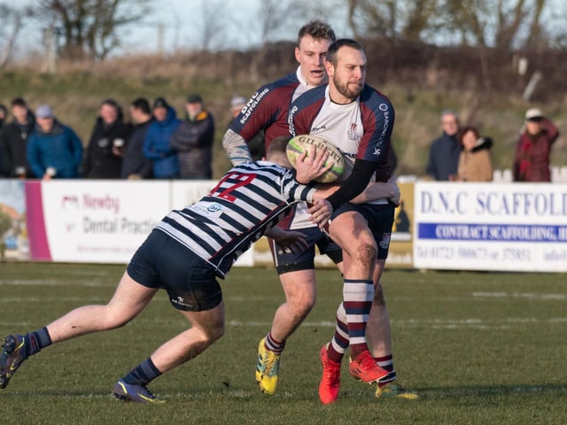 Tom Ratcliffe's progress is halted by a Pocklington tackler