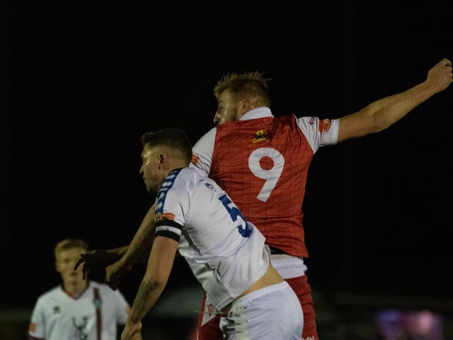 Jake Day wins a header against Whitby Town