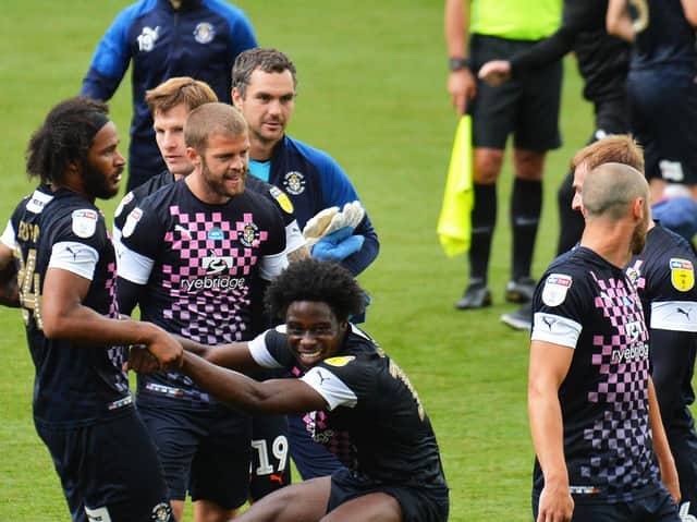 Luton's players celebrate winning 1-0 at Swansea City