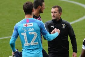 Nathan Jones congratulates Simon Sluga on his clean sheet at Swansea on Saturday