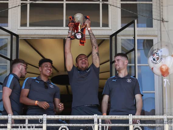 Frankie Musonda celebrates winning promotion to League One in May 2018