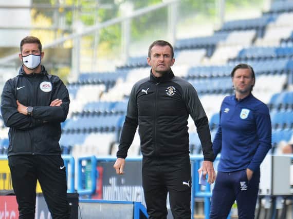 Hatters boss Nathan Jones watches on against Huddersfield this evening
