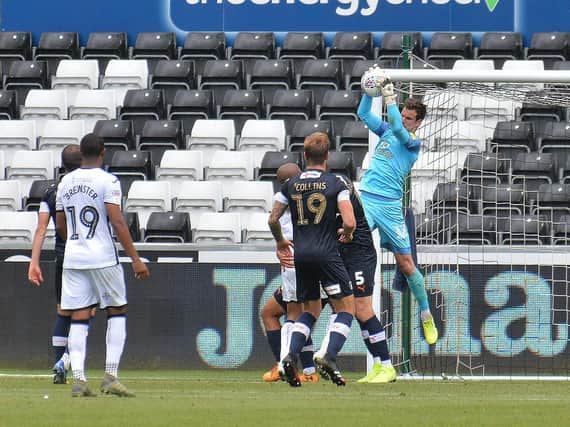 Town keeper Simon Sluga clings on during the 1-0 win at Swansea