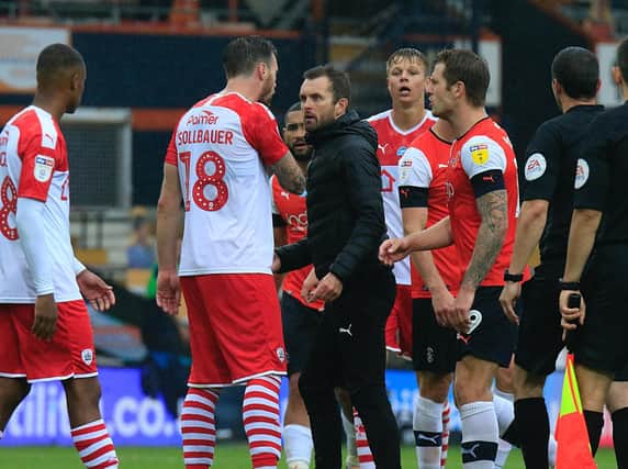 Nathan Jones confronts a Barnsley player after the 1-1 draw at Kenilworth Road last season