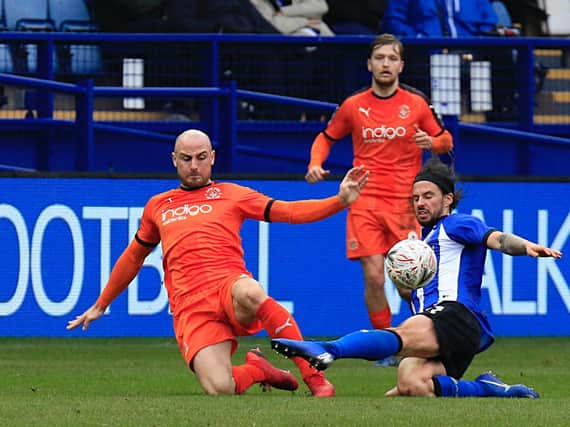 Alan McCormack slides in to win a challenge during his time at Luton