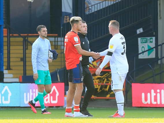 Nathan Jones and Harry Cornick shake hands with Derby attacker Wayne Rooney on Saturday