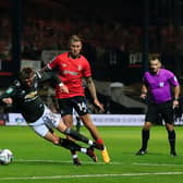George Moncur trips Brandon Williams for Manchester United's penalty at Kenilworth Road this evening