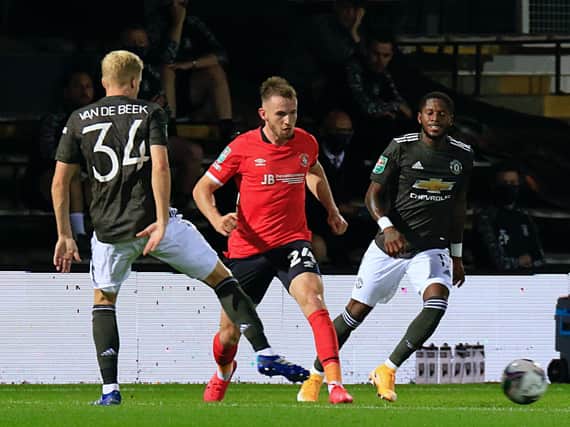 Rhys Norrington-Davies moves the ball against Manchester United