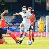 Matty Pearson slides in to tackle Graeme Shinnie during Luton's 2-1 win over Derby recently