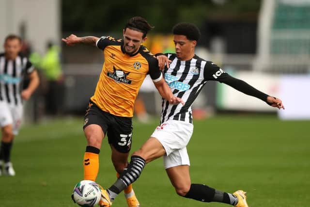Ex-Town youth player Jamal Lewis gets a challenge in for Newcastle United