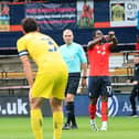 Pelly-Ruddock Mpanzu points to his wrist after curling him the opener against Wycombe on Saturday