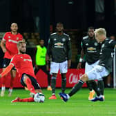 Andrew Shinnie slides in on Donny van de Beek during Luton's Carabao Cup defeat to Manchester United