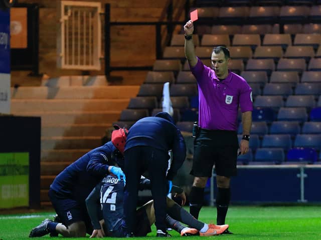 Referee Tim Robinson sends off Forest defender Nicholas Ioannou at Kenilworth Road last night