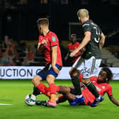 Peter Kioso slides in during his full Luton debut against Manchester United