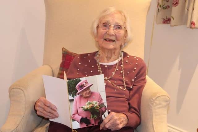 Joan with her birthday card from the Queen
