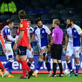 Blackburn's players surround official Gavin Ward after he booked Ben Brereton for diving during the 1-1 draw at Luton