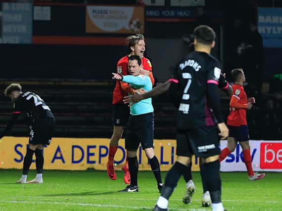 Luke Berry comes into contact with referee Darren England after Luton were awarded a penalty against Norwich on Wednesday night