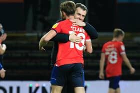 Nathan Jones and Jordan Clark share an embrace after Town beat Norwich City 3-1 on Wednesday night