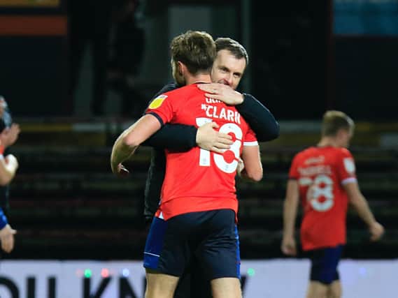 Nathan Jones and Jordan Clark share an embrace after Town beat Norwich City 3-1 on Wednesday night