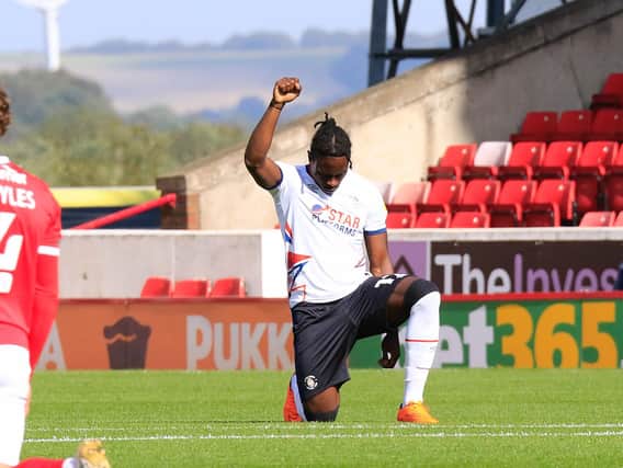 Pelly-Ruddock Mpanzu takes the knee against Barnsley earlier this season