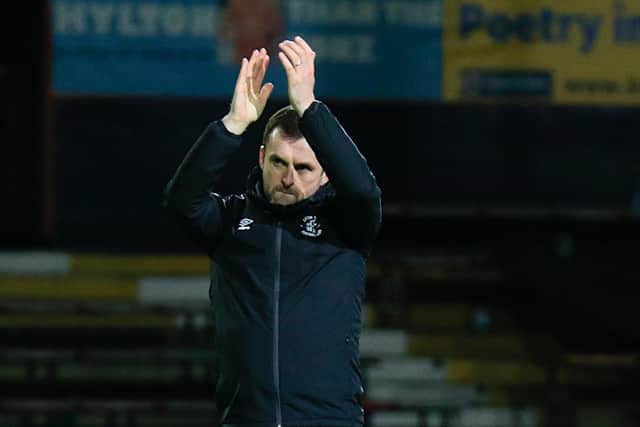 Hatters boss Nathan Jones applauds Town's fans after beating Preston 3-0 this afternoon