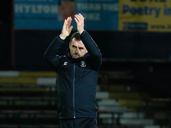 Hatters boss Nathan Jones applauds Town's fans after beating Preston 3-0 this afternoon