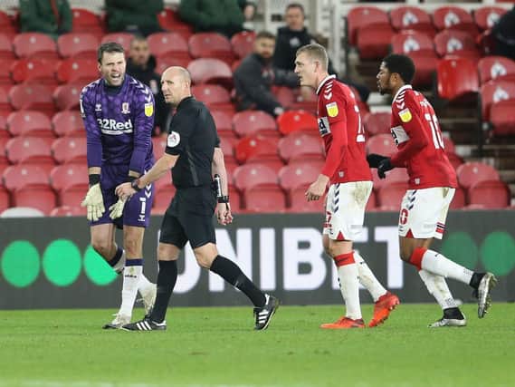 Middlesbrough's players protest to referee Andy Davies this evening