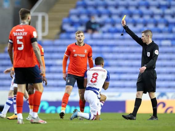 Town's Martin Cranie sees yellow against Reading this afternoon