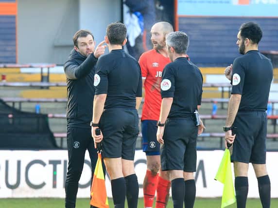 Hatters boss Nathan Jones speaks to the officials after Saturday's 1-0 win over Reading
