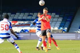 Rhys Norrington-Davies heads clear for the Hatters during Town's 1-0 win over Reading on Saturday