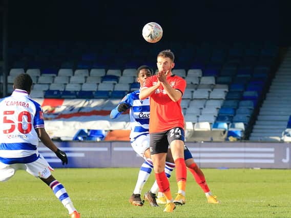 Rhys Norrington-Davies heads clear for the Hatters during Town's 1-0 win over Reading on Saturday